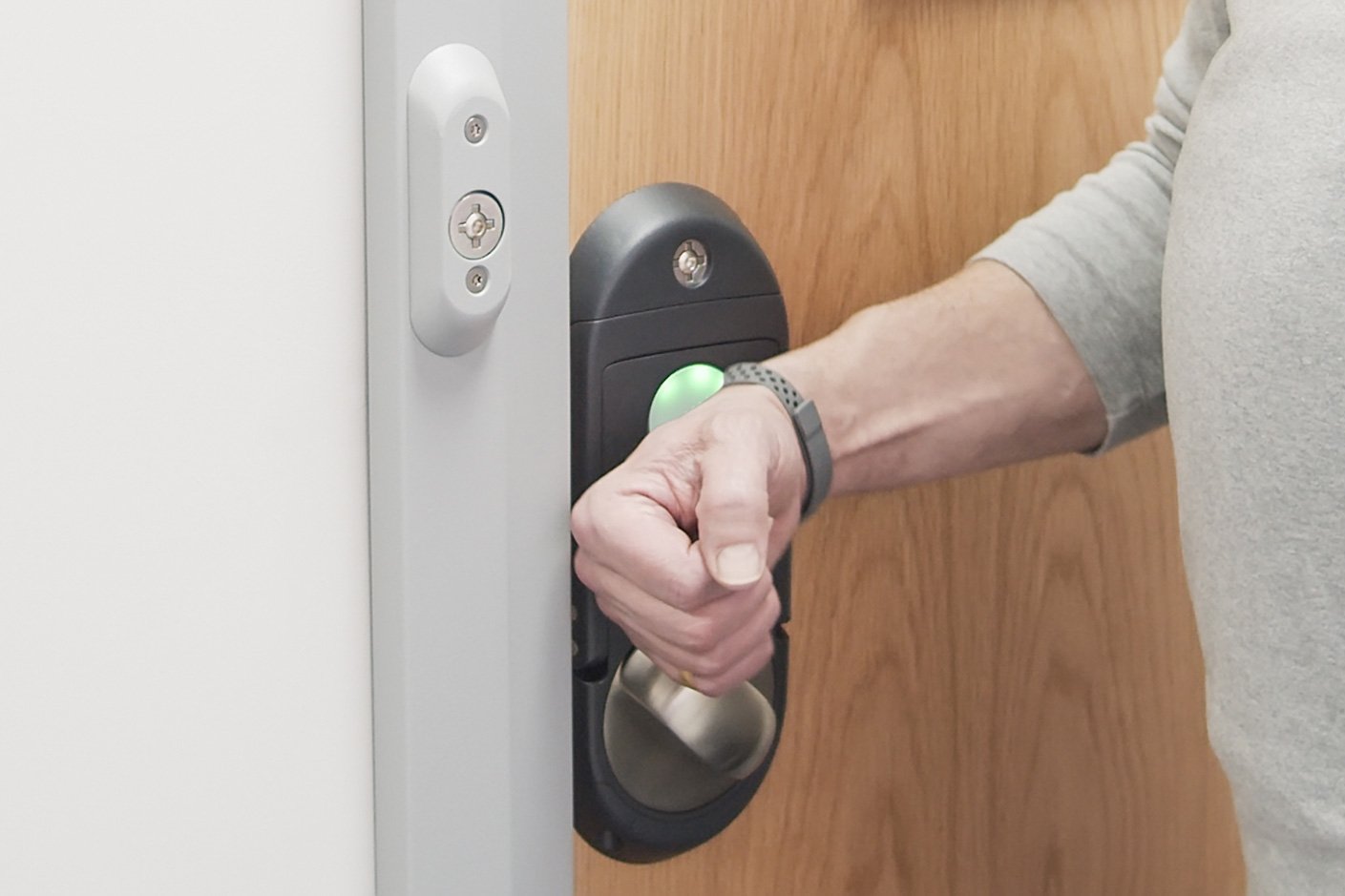Patient unlocking their door with wristband access